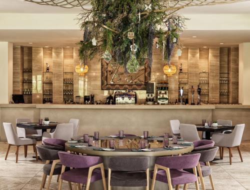 a restaurant with tables and chairs and a bar at Aphrodite Hills Rentals - Elite Villas in Kouklia