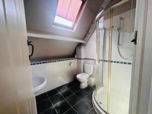 a small bathroom with a toilet and a shower at Broadway House, 7 Bedroom, 6 Baths in Cheltenham