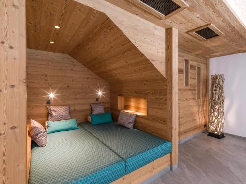 a room with a bed in a wooden house at Gasthof zur Post in Hinterriss