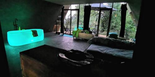 a living room with a couch and a blue light at SOLAR STROH TRIGON nonAC in Niedermuhlern