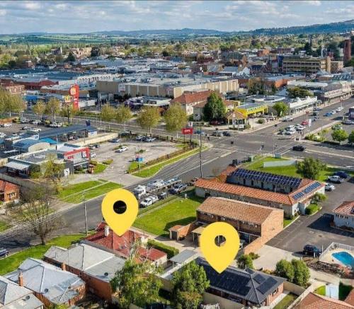 an aerial view of a city with yellow arrows at MèRose Place - Spacious Modern New in Bathurst