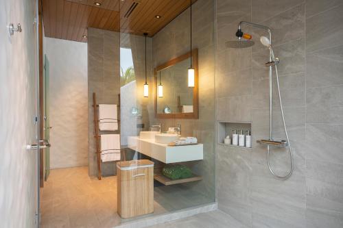 a bathroom with a shower and a sink and a shower at Meliá Phuket Mai Khao in Mai Khao Beach