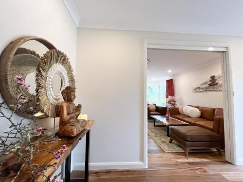 a living room with a couch and a mirror at Birdwood Guesthouse in Blackheath