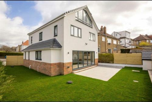 a large white house with a green yard at The View in Leeds