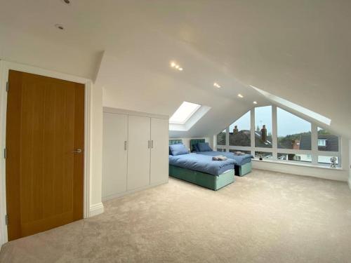 a bedroom with a blue bed and a large window at The View in Leeds