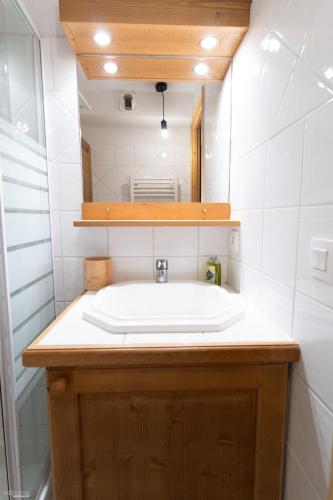 une salle de bain avec un lavabo et un miroir dans l'établissement 2 pièces proche pistes Les Saisies, à Villard-sur-Doron