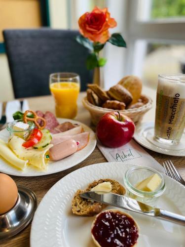 a table topped with plates of food and drinks at ACHAT Hotel Monheim am Rhein in Monheim