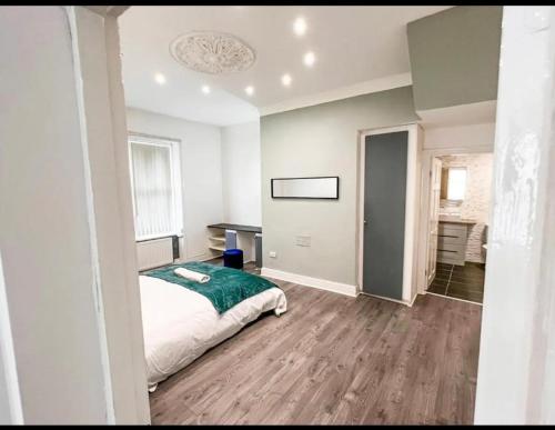 a bedroom with a bed with a green blanket at Lovely 1-bedroom apartment, free street parking in Elswick