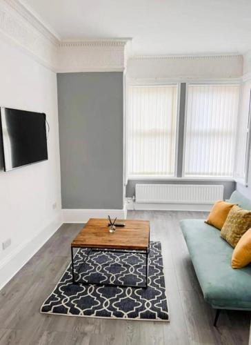 a living room with a couch and a coffee table at Lovely 1-bedroom apartment, free street parking in Elswick