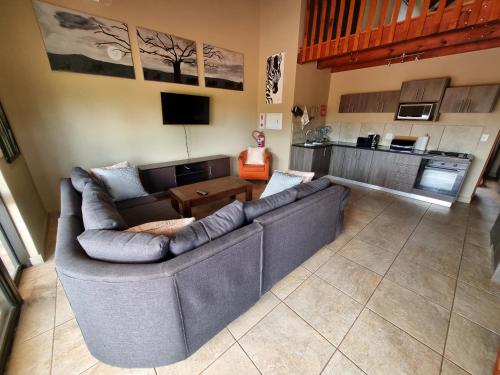 a living room with a couch and a table at Sondela Nature Reserve & Spa Chalets in Bela-Bela