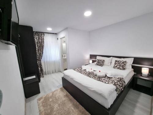 a bedroom with a large bed and a television at Casa Thor in Sinaia