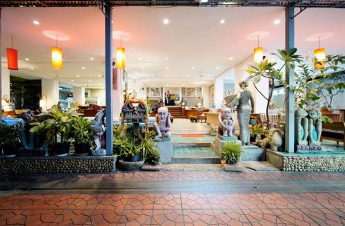 a store with potted plants in the lobby at Wild Orchid Villa in Bangkok