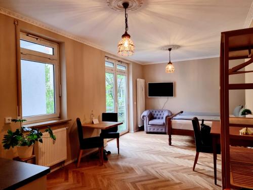 a living room with a bed and a table and chairs at Das Altschwabing - Munich Boutique Hotel in Munich