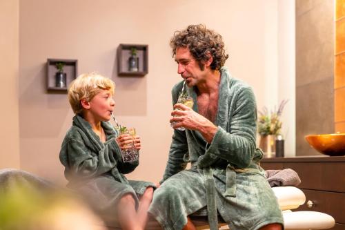 a man and a young girl drinking wine at Ferienhäuser Saalemaxx in Rudolstadt