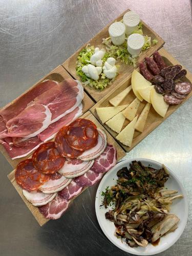 a table topped with different types of meats and cheese at Agriturismo Maneggio Vallecupa in Pescasseroli