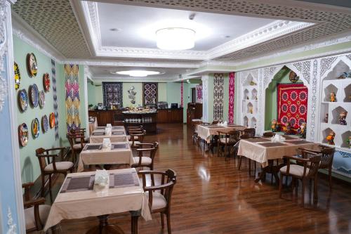 a restaurant with tables and chairs in a room at Sangzor Boutique Hotel in Samarkand