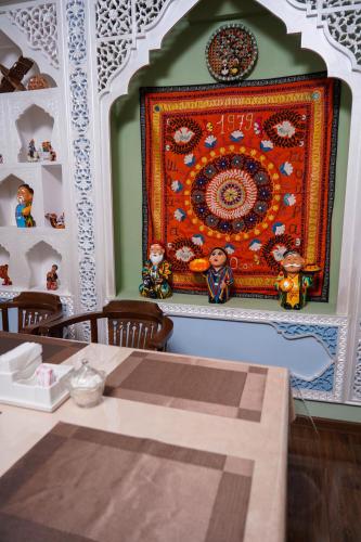 a rug hanging on a wall in a room at Sangzor Boutique Hotel in Samarkand