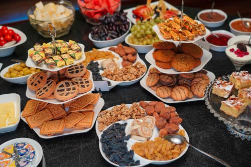 a table full of different types of food on plates at Sangzor Boutique Hotel in Samarkand
