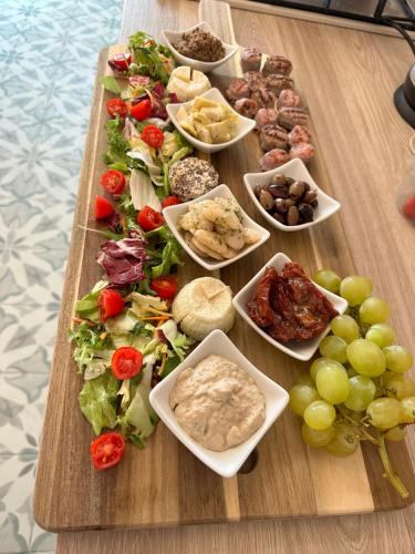 a table with a bunch of different types of food at Ta' Ġilarda Boutique Living in Birbuba