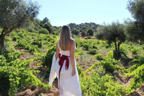 a woman in a white dress walking through a field at Casa rural en El Burguillo -Vitalia 2 CR-AV-1251 in Las Cruceras