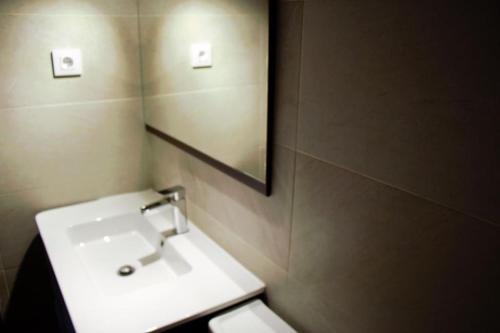 a bathroom with a white sink and a mirror at Casa rural en El Burguillo -Vitalia 2 CR-AV-1251 in Las Cruceras