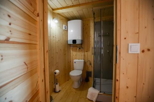 a wooden bathroom with a toilet and a shower at Jurta Rokitek61 in Sandomierz