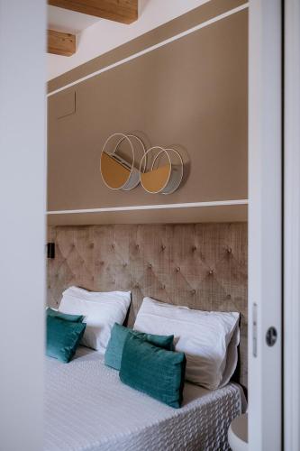 a bedroom with a bed with two mirrors on the wall at Hotel Venezia in Trento
