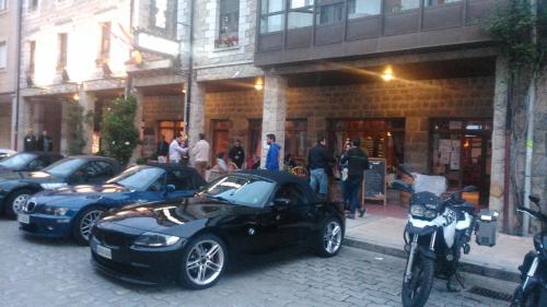 a group of cars parked in front of a building at Hostal Sainz in Riaño