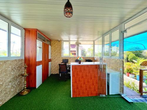 a room with a counter with green flooring and windows at Bell Farms and Resorts in Munroe Island