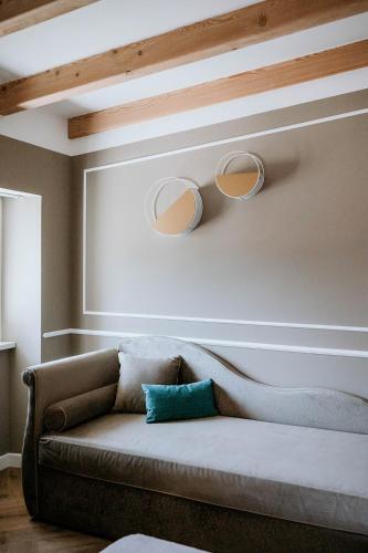 a couch in a living room with two lights on the wall at Hotel Venezia in Trento