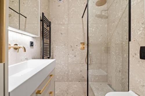 a bathroom with a sink and a shower at Brand New Downtown Harbor Apartment in Reykjavík