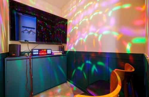 a room with a chair and a wall with neon lights at STAY201 in Jecheon