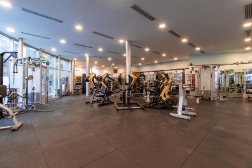 a gym with treadmills and machines in a room at Holiday Inn Kuwait by IHG in Kuwait