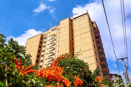 a tall building with flowers in front of it at Elegant Furnished 2 bedroom Apartment in Nairobi Ngara in Nairobi