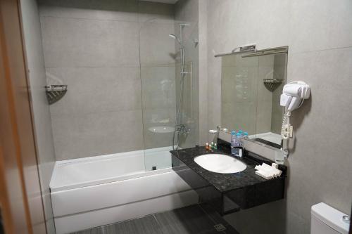 a bathroom with a sink and a shower at Sangzor Boutique Hotel in Samarkand