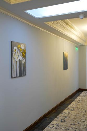 two pieces of art on a wall in a room at Sangzor Boutique Hotel in Samarkand