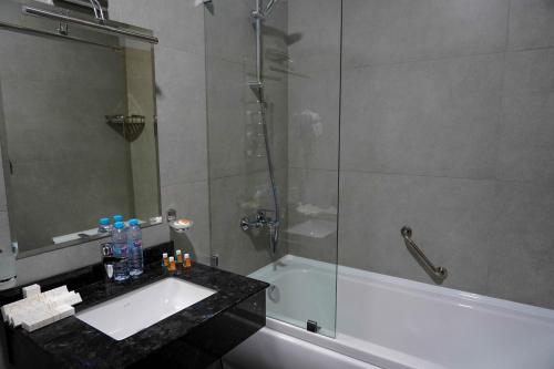 a bathroom with a tub and a sink and a shower at Sangzor Boutique Hotel in Samarkand