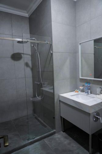 a bathroom with a glass shower and a sink at Sangzor Boutique Hotel in Samarkand