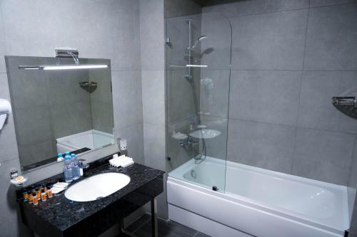 a bathroom with a sink and a shower and a tub at Sangzor Boutique Hotel in Samarkand