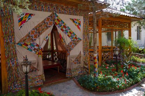 a house with a tent in a garden with flowers at Sangzor Boutique Hotel in Samarkand