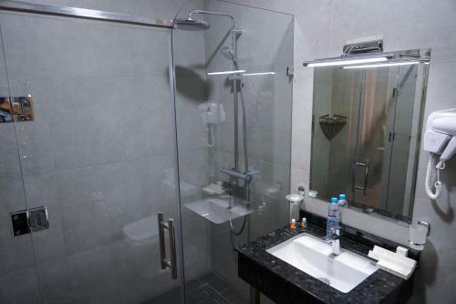 a bathroom with a glass shower and a sink at Sangzor Boutique Hotel in Samarkand