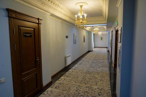 a hallway with a chandelier and a long corridor at Sangzor Boutique Hotel in Samarkand