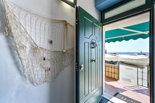 a door to a balcony with a view of the ocean at IL RIFUGIO SUL MARE - GenovaInRelax in Genova