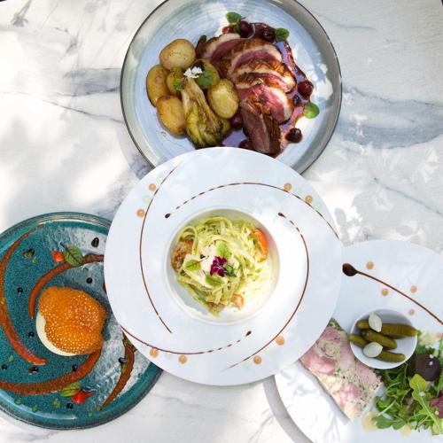 a table with two plates of food on it at Hotel Saint Regis in Chalon-sur-Saône