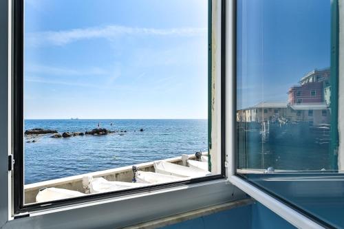 a view of the ocean from a window at IL RIFUGIO SUL MARE - GenovaInRelax in Genova