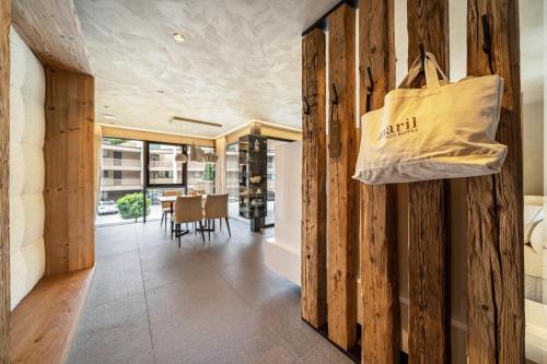 a shopping bag hanging on a wall in a dining room at Boutique Hotel AMARIL in Castelbello-ciardes