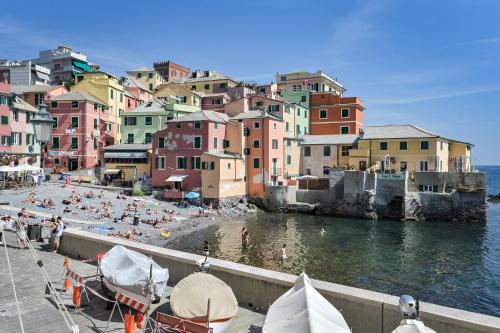 a group of people on a beach near the water at IL RIFUGIO SUL MARE - GenovaInRelax in Genova