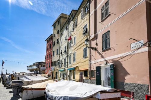 a street with boats parked in front of buildings at IL RIFUGIO SUL MARE - GenovaInRelax in Genova