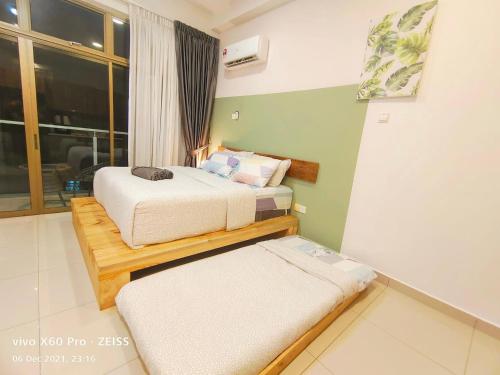 a bedroom with two beds and a window at Austin Palazio @B2/Pool view in Johor Bahru