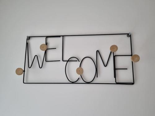 a glass sign that reads welcome with the word love at Le toit de Chardonne - Entre Alpes et lac Léman in Chardonne